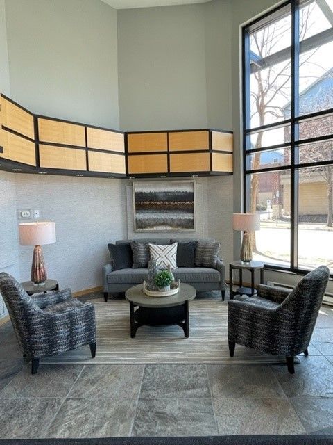 A living room with a couch , chairs and a coffee table