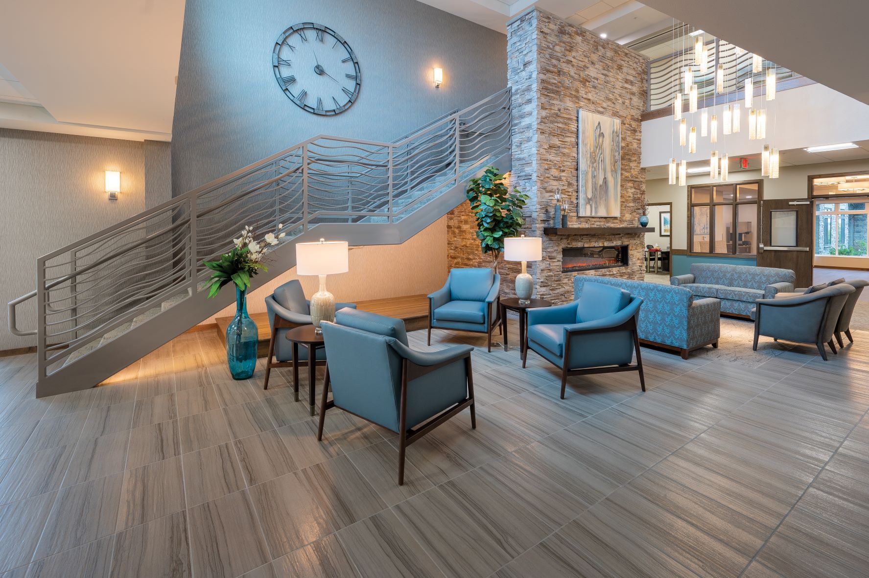 A living room filled with furniture and a clock on the wall.