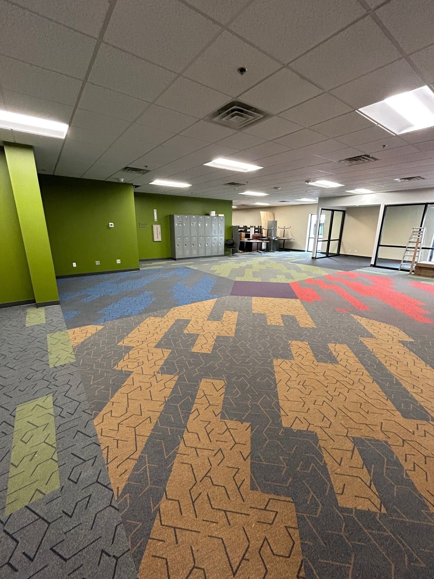 A large empty room with a puzzle pattern on the floor.