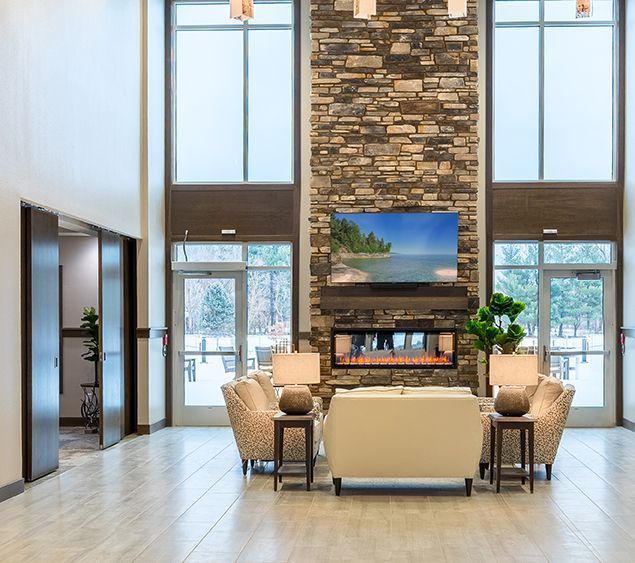 A living room with a fireplace and a flat screen tv