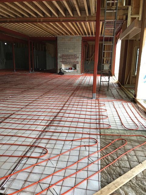 A room with a fireplace and a lot of wires on the floor