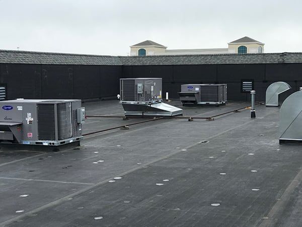 A rooftop with a lot of air conditioning equipment on it
