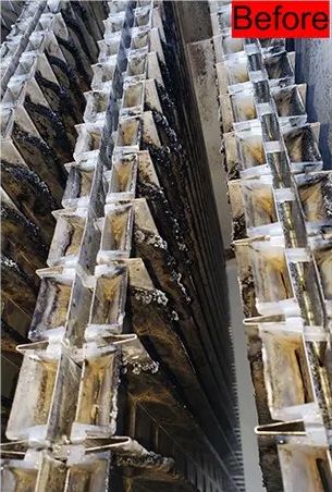 Close-up view of metal cooling tower components. Angled, geometric design with dark and silver elements.