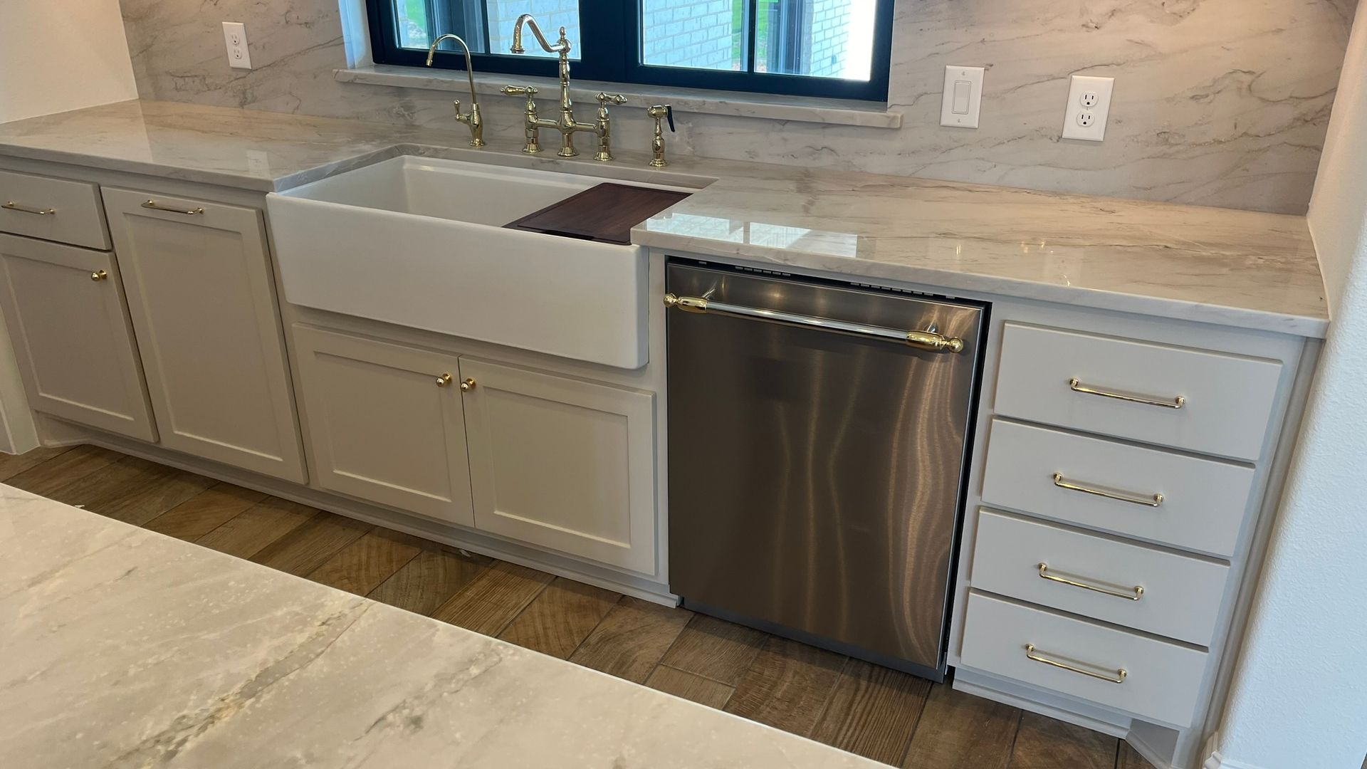 A kitchen with a sink and a stainless steel dishwasher