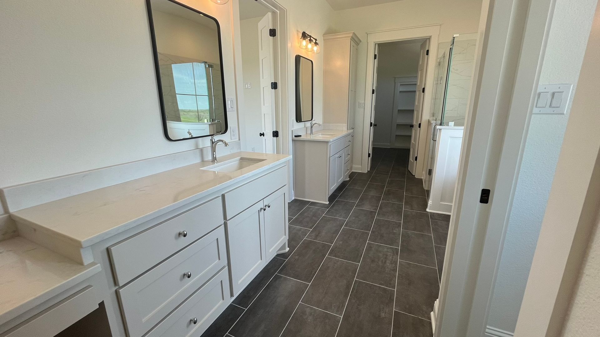 A bathroom with two sinks and two mirrors