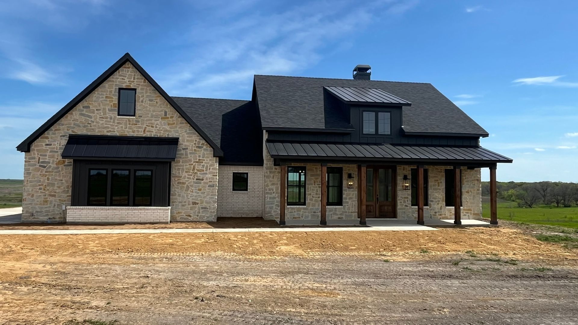 A large brick house with a black roof
