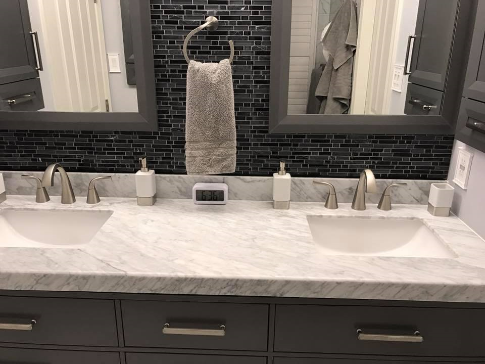 A bathroom with two sinks and two mirrors