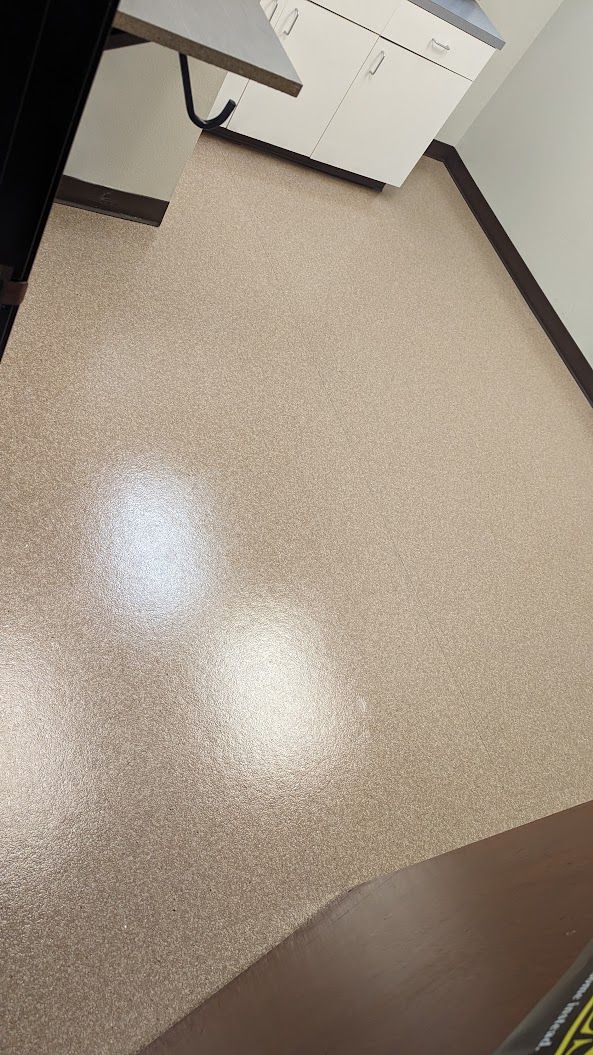 Empty beige office floor with cabinets and part of a desk visible