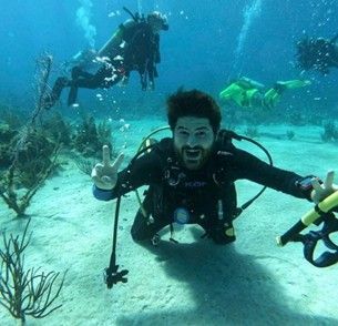 A group of scuba divers are swimming in the ocean.