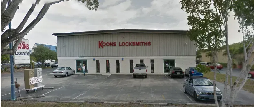 Krohn Locksmiths storefront with parked cars in front on a cloudy day