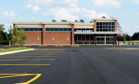 A large brick building with a parking lot in front of it