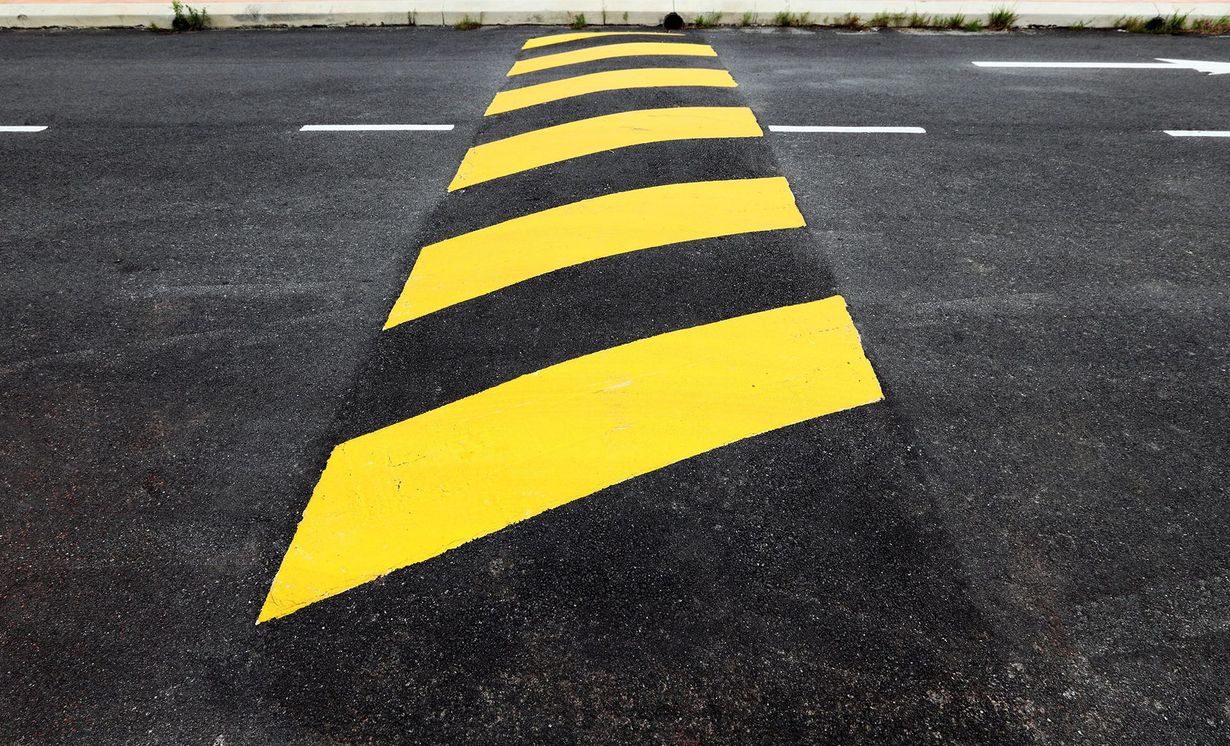 A yellow and black strip on the side of a road