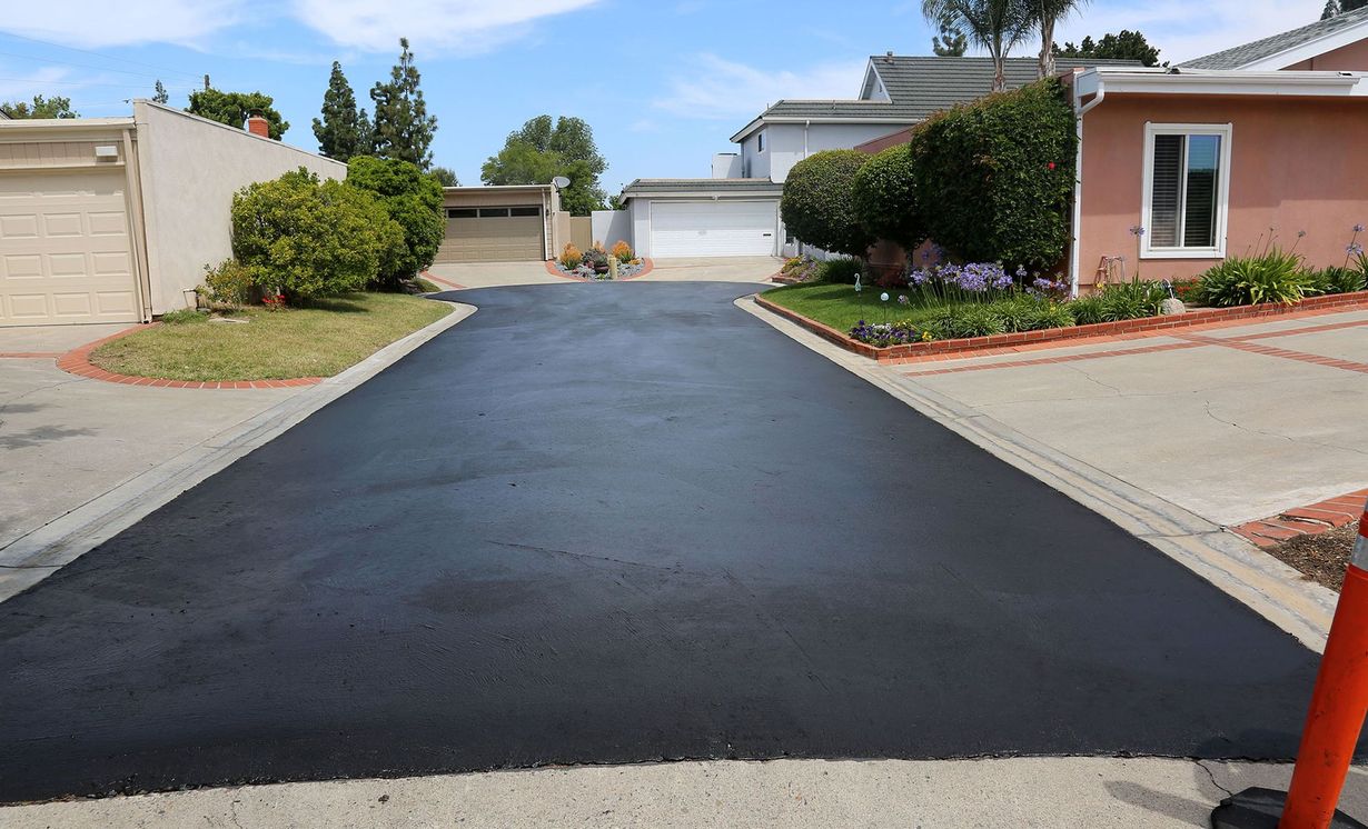 A newly paved driveway in a residential neighborhood