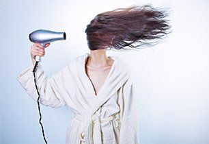 Girl using blow dryer