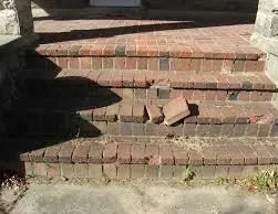 Brick steps with broken bricks, cast shadow.