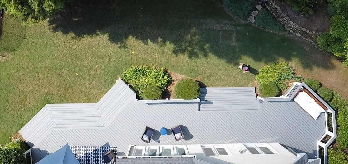 An aerial view of a large house with a large deck.