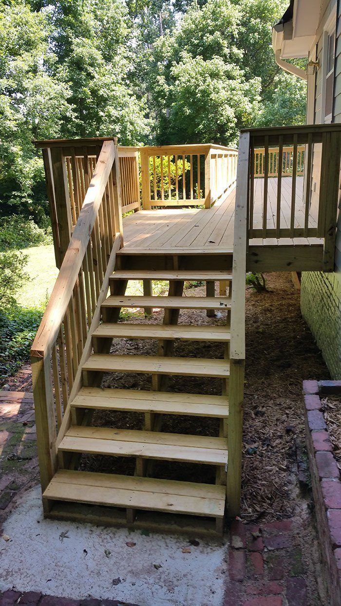 A wooden deck with stairs leading up to it.