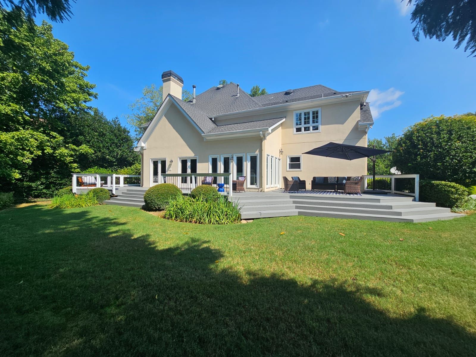 A large house with a large lawn in front of it.