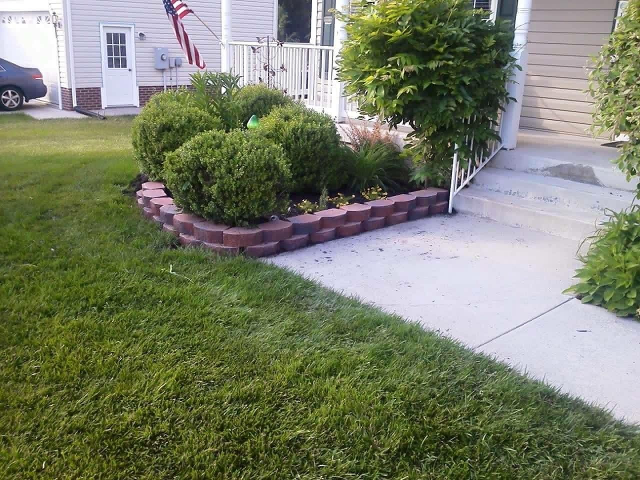 A house with a brick planter in front of it