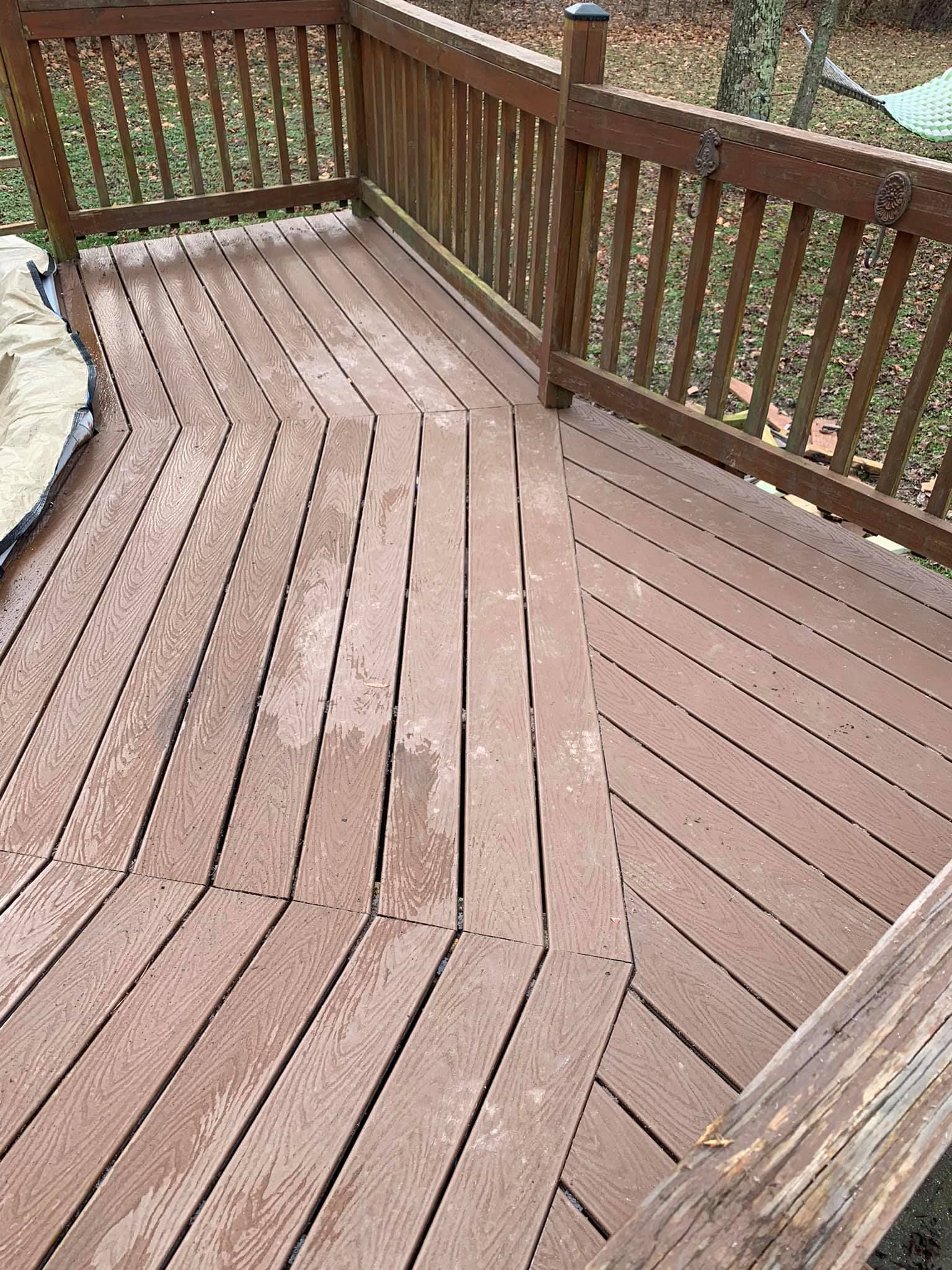 A wooden deck with a wooden fence around it.