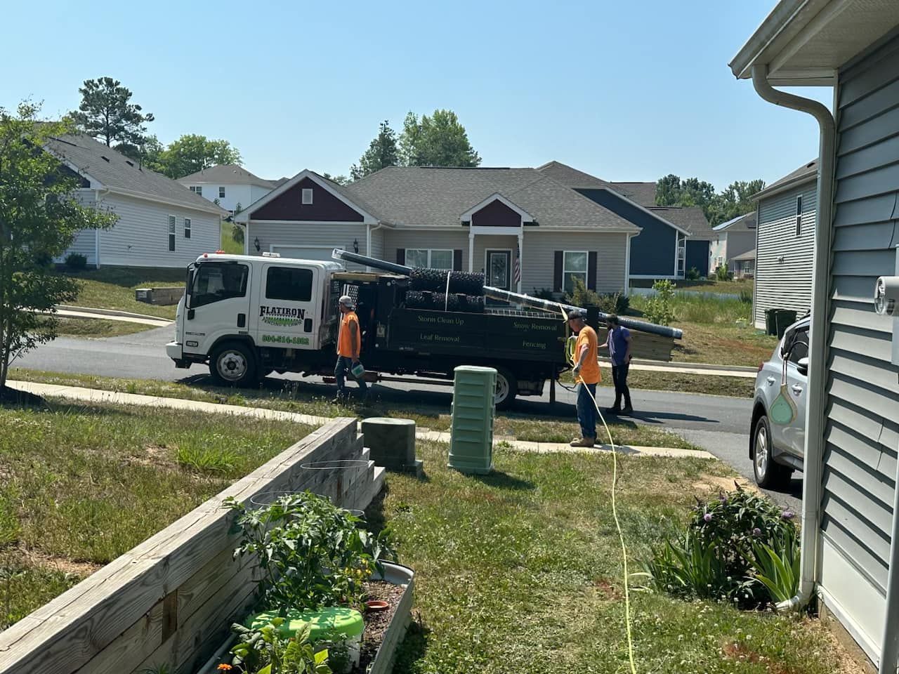 A truck is parked in front of a house in a residential neighborhood.