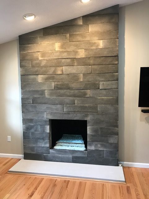 A living room with a fireplace and a flat screen tv