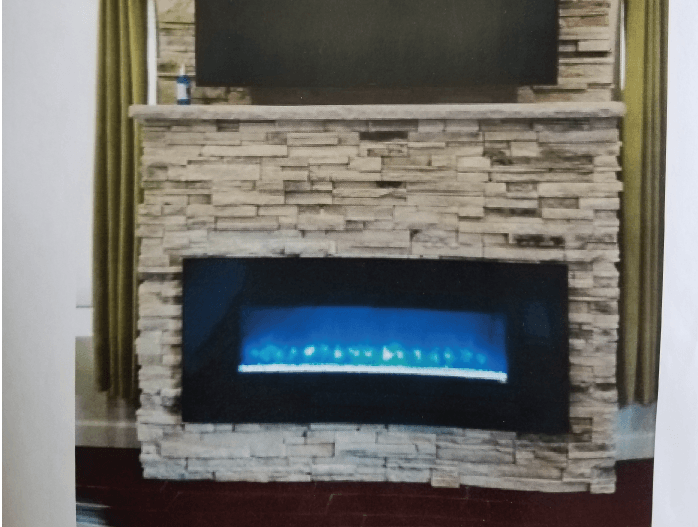 A picture of a fireplace with a television above it