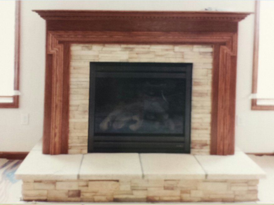 A brick fireplace with a wooden mantle