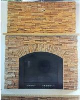 A fireplace with a brick wall and a black door.