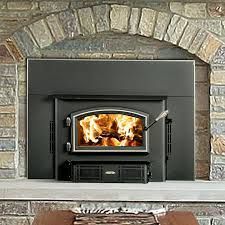 There is a fireplace with a wood stove in it.