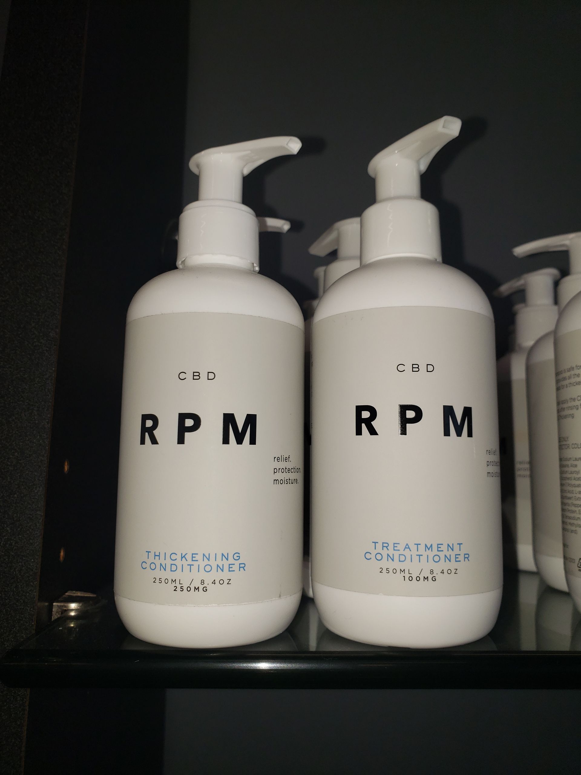 Two bottles of rpm lotion are on a shelf