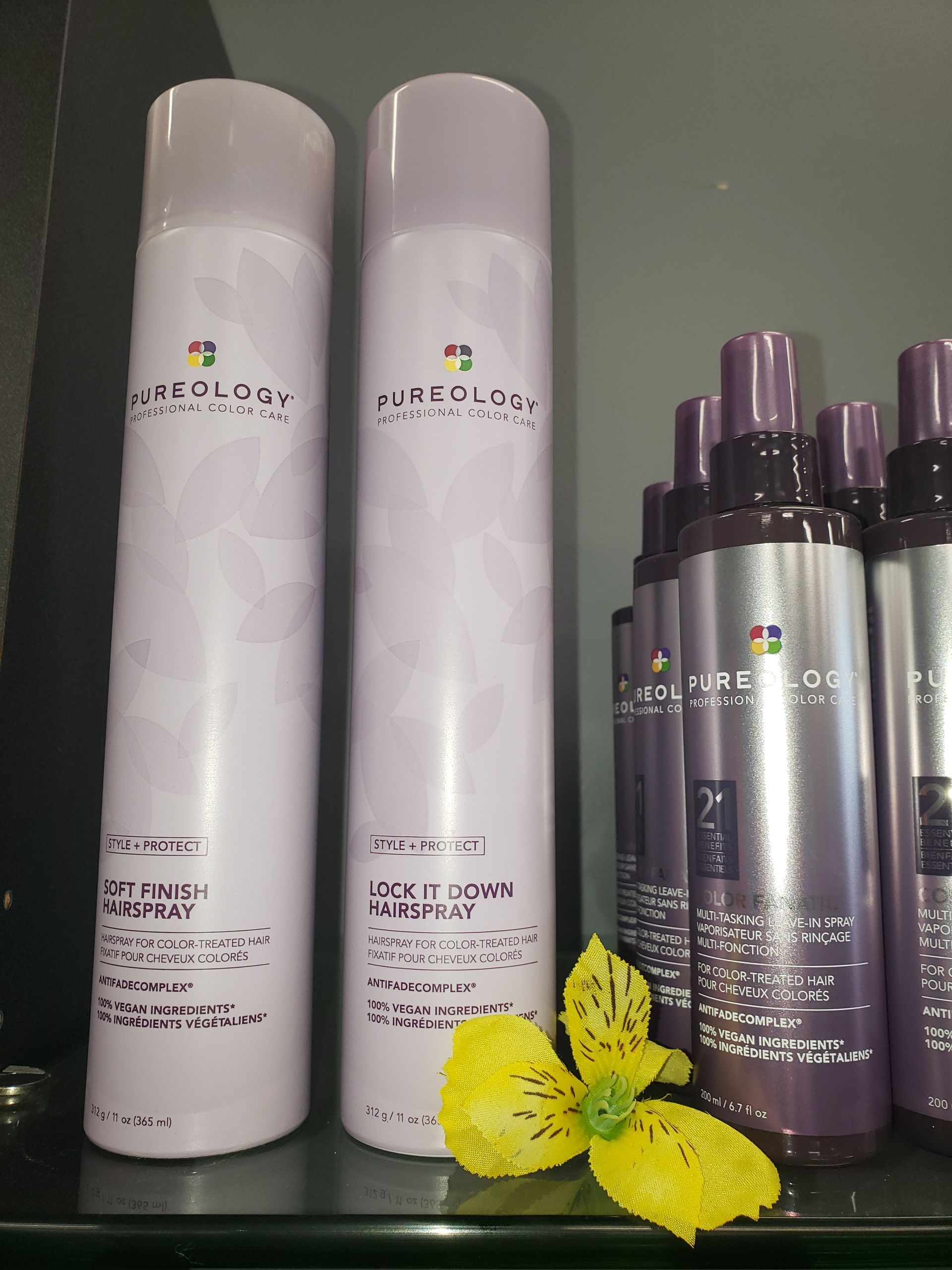 Purple bottles of hair products are on a shelf