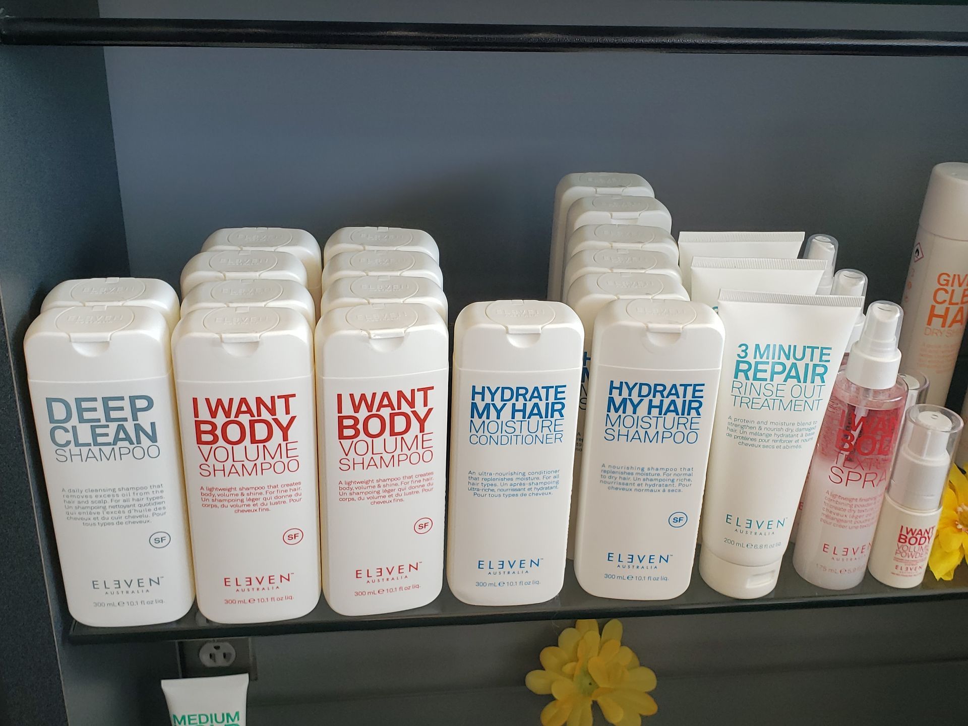 A shelf filled with bottles of i want body shampoo