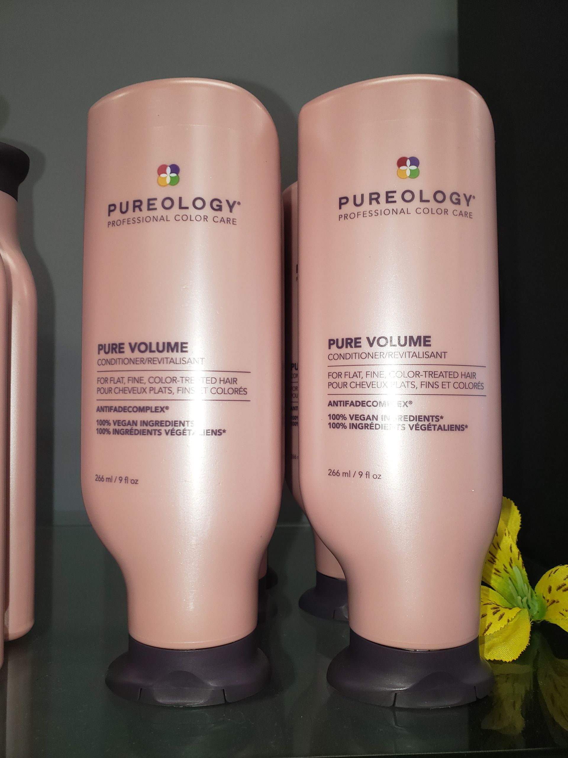 Two bottles of pureology pure volume shampoo and conditioner