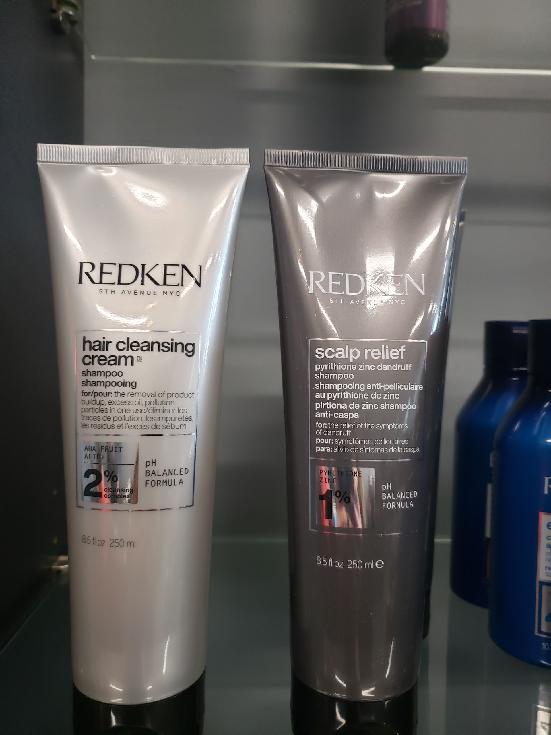 Two bottles of redken hair products on a shelf