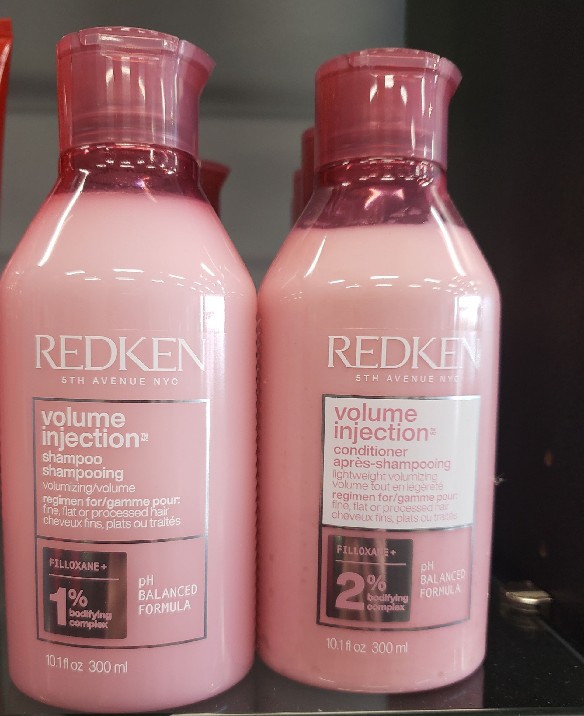 Two bottles of redken volume injection shampoo and conditioner