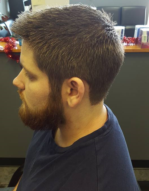 A man with a beard is wearing a blue shirt