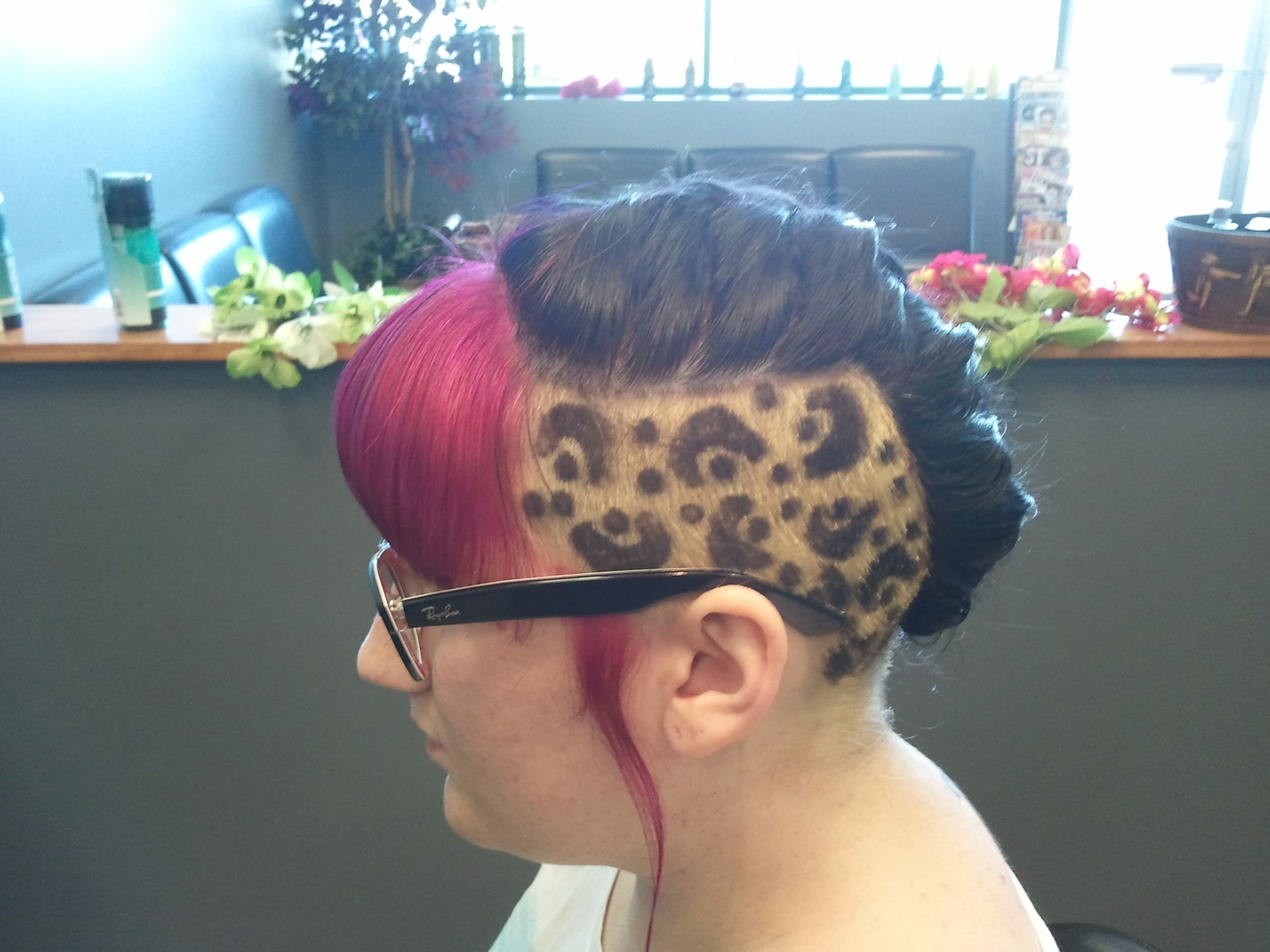 A woman with glasses has a leopard print on her head