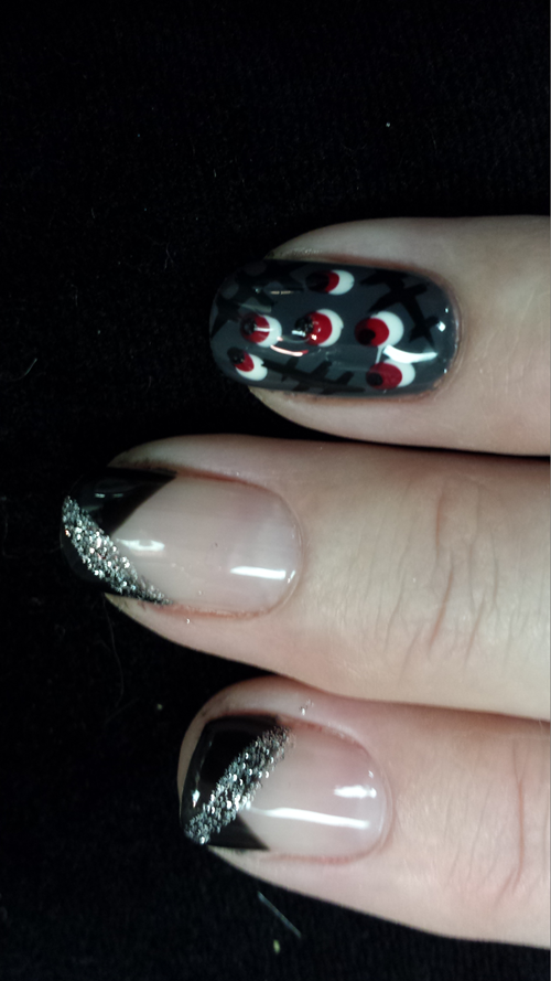 A close up of a person 's nails with a design on them