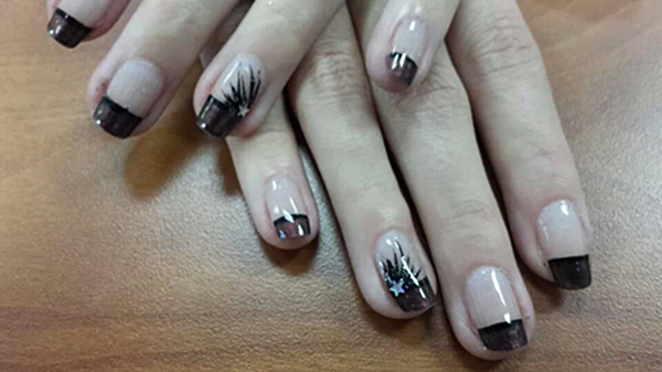 A close up of a person 's nails with a design on them