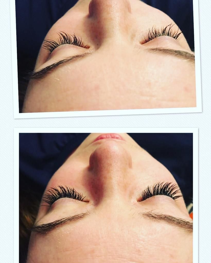 A close up of a woman 's face with her eyelashes.