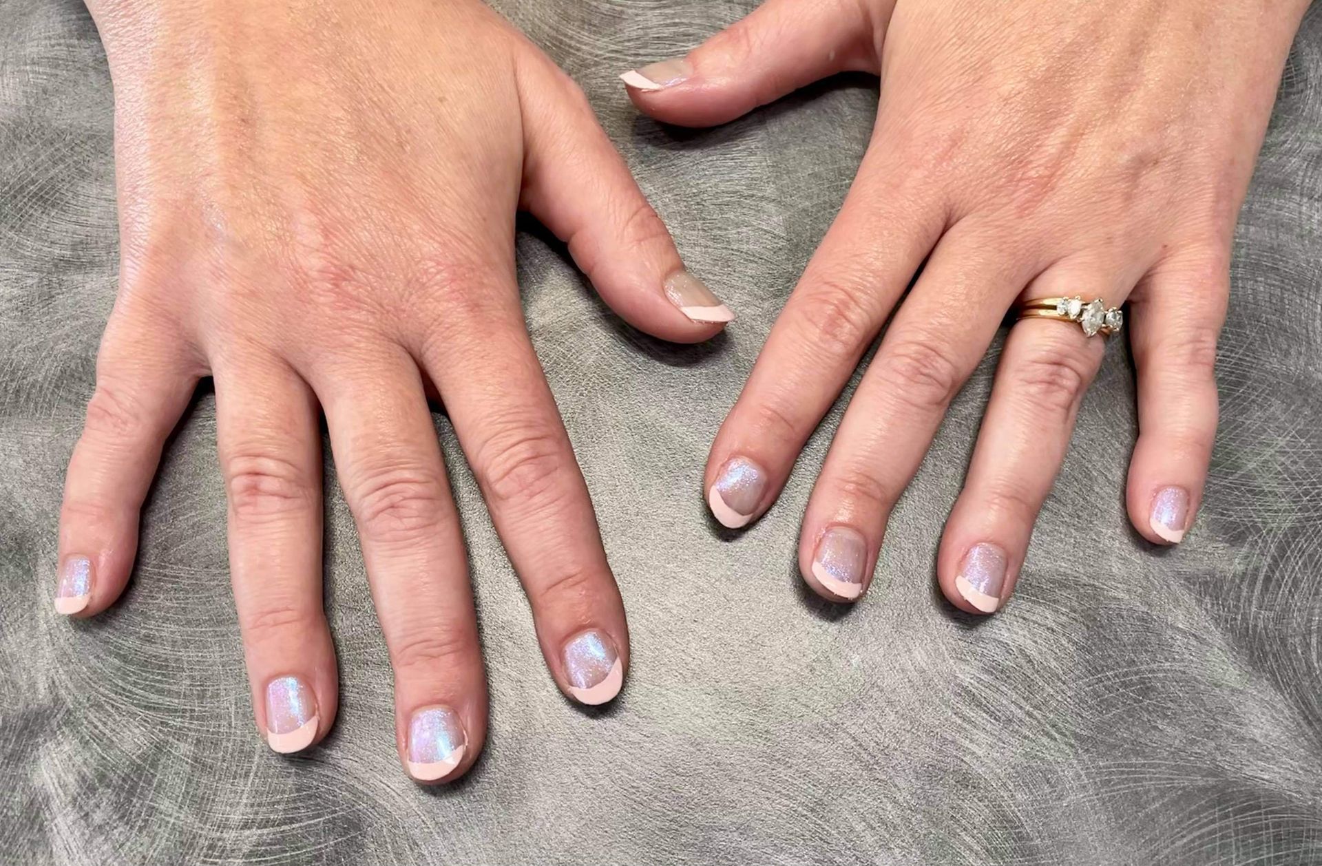 A close up of a woman 's hands with a ring on her finger.