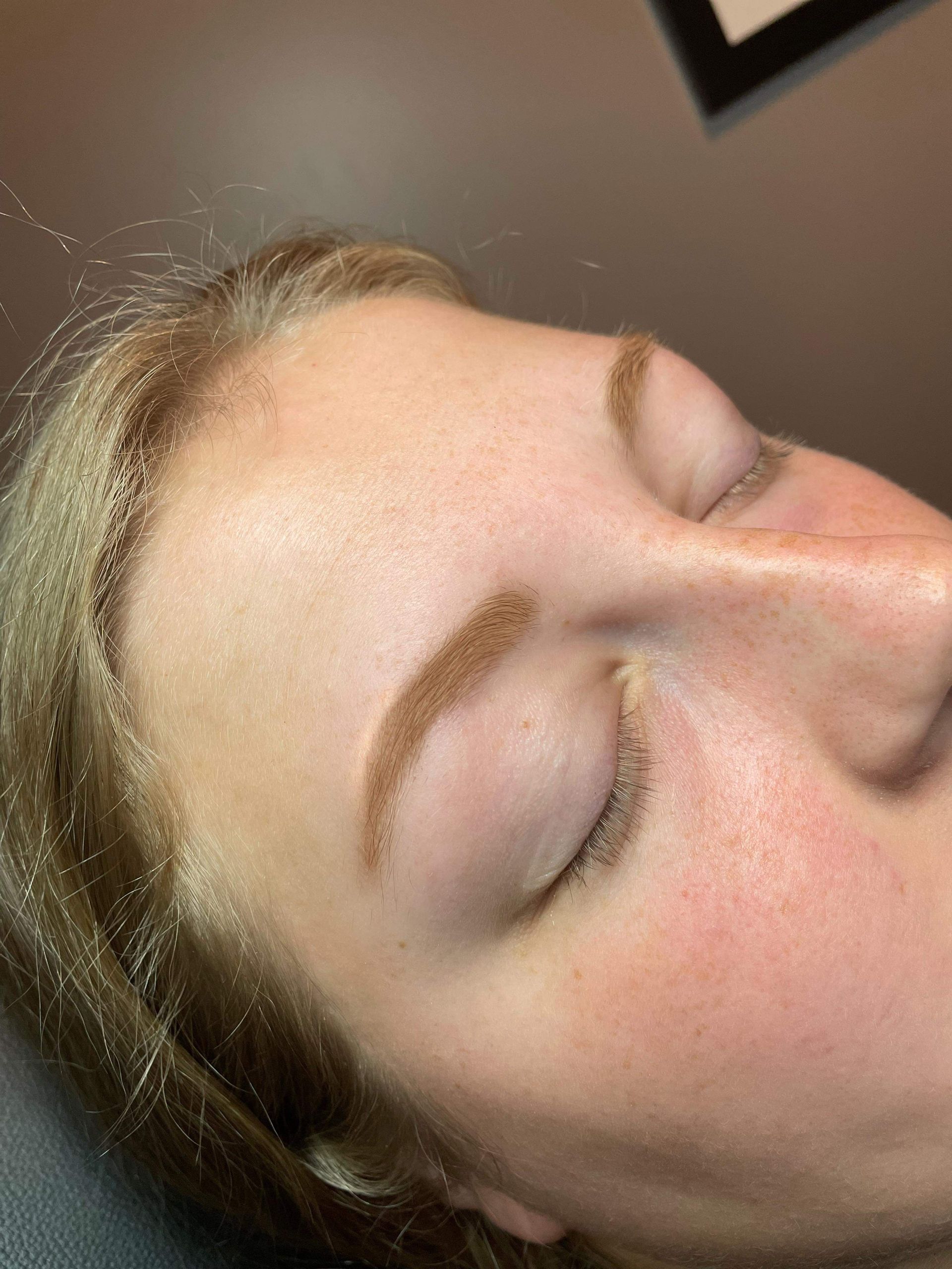 A close up of a woman 's face with her eyes closed.