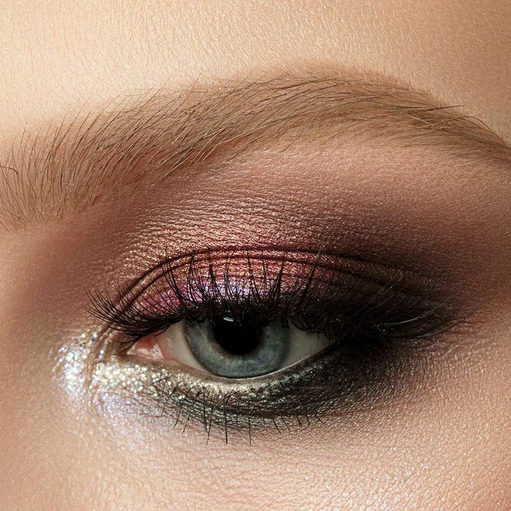A close up of a woman 's eye with smokey eye makeup