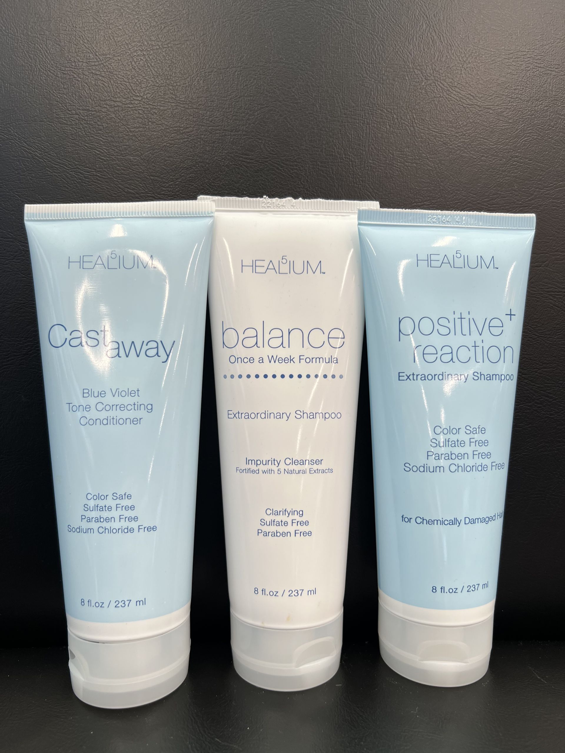 Three tubes of cashway lotion are lined up on a table