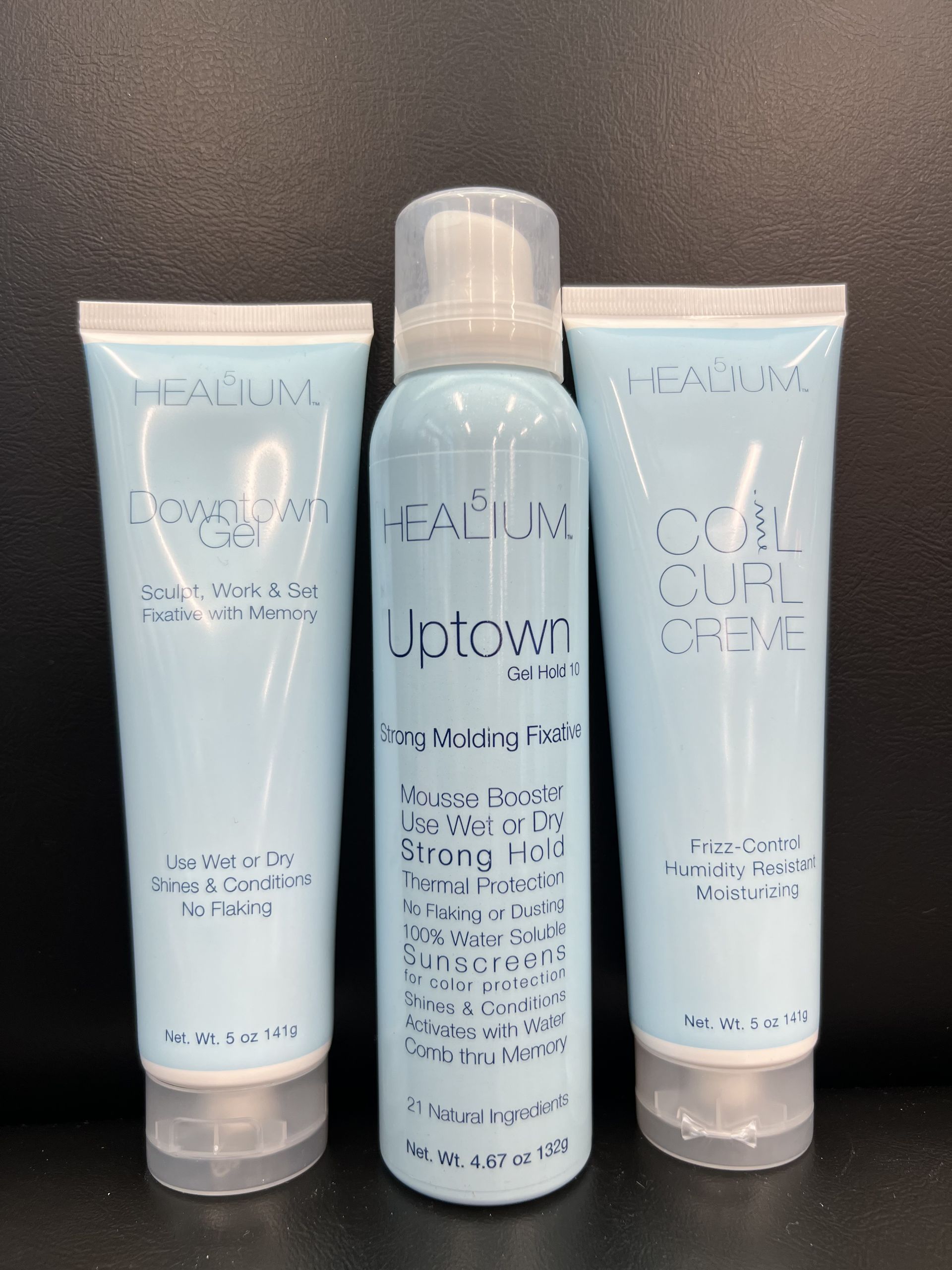 Three bottles of j.plown hair products are sitting on a table