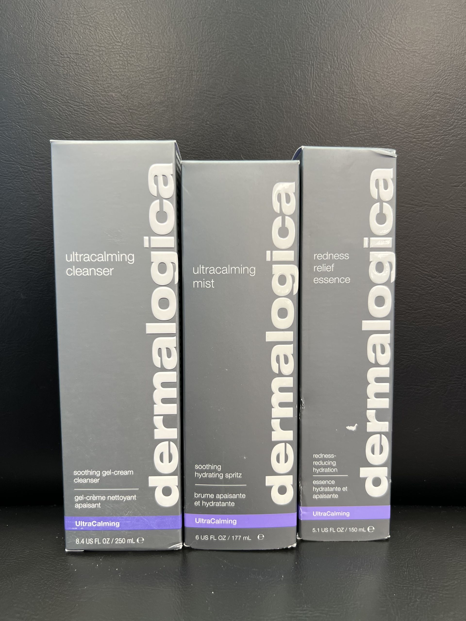Three boxes of dermalogica products are lined up on a table