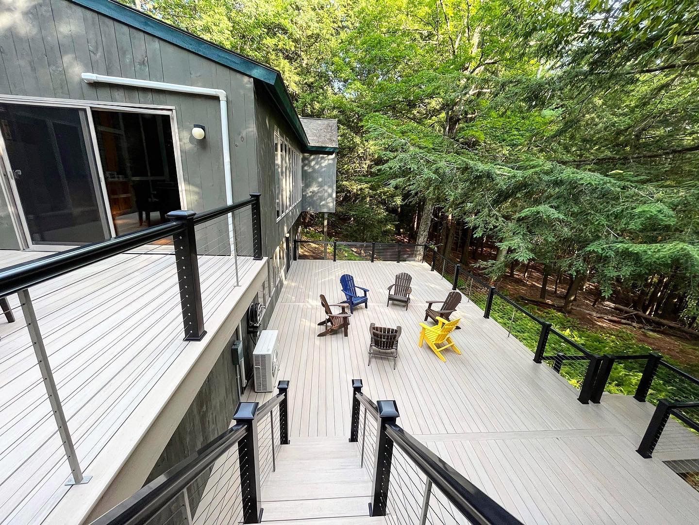 An aerial view of a deck with chairs and stairs leading to it.