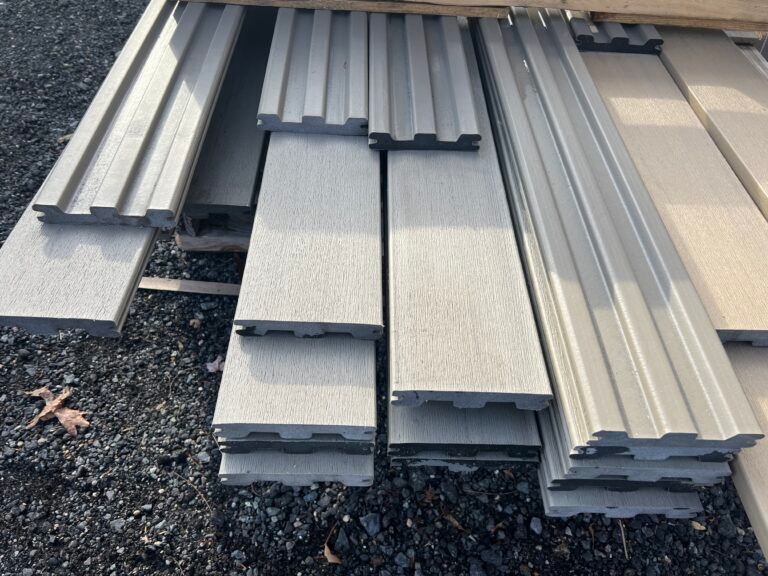 A stack of gray metal pieces laying on the ground