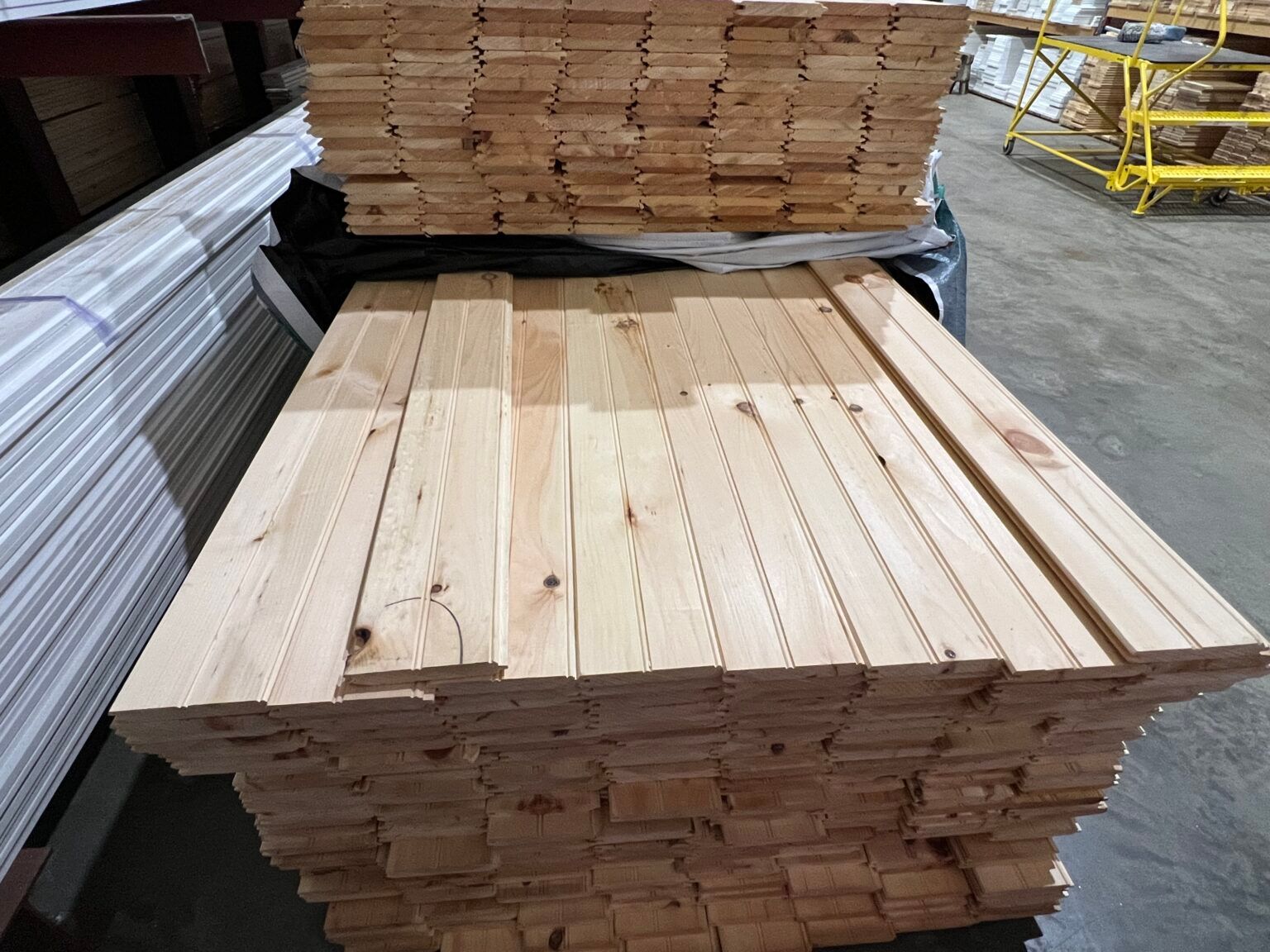 A pile of wood is stacked on top of each other in a warehouse.